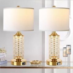 two lamps sitting on top of a table next to each other