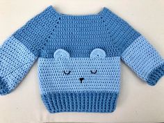 a crocheted sweater with a bear face on it