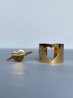 Give one to a friend for matching bestie rings or keep both for yourself! They look so cute stacked next to each other. The Heart of Gold Set are adjustable so no need to worry about getting the correct size. The perfect ring to wear alone or to combine with other fine rings. The ring is made of stainless steel, so waterproof! The color remains perfect. Sold as a set. Gold: 18k gold platedMaterial: Stainless steelSize: Adjustable so you don't have to worry about sizing Waterproof jewelry Hypoall Trendy Adjustable Stackable Rings For Anniversary, Adjustable Yellow Gold Heart Midi Rings, Adjustable Heart-shaped Yellow Gold Midi Rings, Stackable Heart-shaped Open Ring As Gift, Stackable Open Heart Ring As Gift, Stackable Open Heart Ring Gift, Adjustable Yellow Gold Open Heart Ring, Adjustable Heart-shaped Stackable Yellow Gold Rings, Adjustable Stackable Heart Ring As Gift