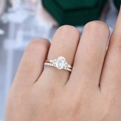 a woman's hand with a diamond ring on it