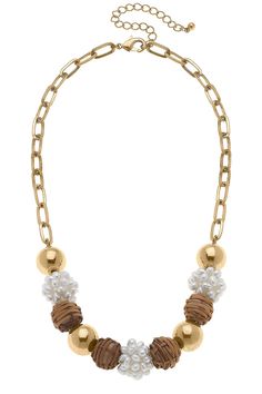 Enhance your look with this classic, yet unique Bella Pearl Cluster & Wicker Ball Bead Necklace in Brown. This artisanal jewelry piece combines a timeless elegance with a touch of exotic flair from the wicker-style ball bead, all to create a one-of-a-kind look. The rich tones of brown evoke a sense of tropical warmth, so you can add the perfect hint of sophistication to any outfit. DETAILS: Base Metal with Worn Gold Plating Wicker & Pearls 18" Adjustable Length Gold Necklaces With Round Beads For Fashion, Elegant Wooden Beads Jewelry For Beach, Elegant Wooden Beaded Necklaces For Beach, Elegant Gold Beaded Necklaces With Wooden Beads, Elegant Gold Beaded Necklace With Wooden Beads, Elegant Wooden Beads Necklace For The Beach, Elegant Wooden Beads Necklace, Elegant Necklaces With Wooden Beads, Elegant Brown Beaded Necklaces For Beach