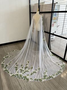 a white wedding veil with flowers on it