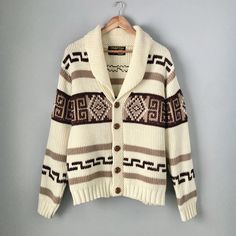 "Amazing 1970s vintage button-down cardigan sweater by Charter Oak. Fans of The Big Lebowski might find this sweater familiar! Although it's not the same Pendleton Westerley sweater that was worn in the movie, the design is quite similar and has the same vibe. The original Pendleton sweater debuted in 1972 with many companies producing their own versions with differences in the patterns and details (like the wood buttons instead of a zipper). Made with 100% virgin acrylic yarn. Made in Taiwan. Machine washable. In excellent vintage condition, just has a small stain on one of the arms and a larger but more faint blotch of discolouration on the other, as pictured. Both are hardly noticeable when worn. Men's size Large, fits on the smaller size of that (more like a men's medium). Could also f Vintage Knitted Sweater Coat For Fall, Brown Cotton Cardigan With Button Closure, Retro Knitted Outerwear For Fall, Retro Knitted Cardigan For Fall, Retro Knitted Fall Cardigan, Brown Button-up Cotton Cardigan, Brown Button-up Cotton Sweater, Brown Cotton Button-up Sweater, Retro Knitted Long Sleeve Outerwear