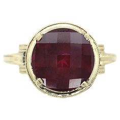 14K yellow gold ring with white gold filigree set with a large round rhodolite garnet. The garnet weighs 4 1/2 carats and measures about 10mm. The garnet has raspberry darker pink color with a specialty checkerboard top. The ring fits a size 8.5 finger and weighs 2.5dwt. It dates from the 1950-60's. Timeless Amethyst 14k Gold Ring, Timeless Round Amethyst Ring In 14k Gold, Timeless 14k Gold Amethyst Ring, 14k Gold Filigree Ring, 14k Gold Ruby Ring With Bezel Setting, Classic 14k Gold Ruby Ring With Round Stone, Formal Round Ruby Ring Stamped 14k, Luxury 14k Gold Round Ruby Ring, Yellow Gold Filigree Ring With Center Stone