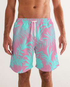 Men's Swimsuit, Tropical Foliage Pink and Teal Blue Pink and Teal Tropical Floral Leaf swim trunks. Bright turquoise blue and vibrant pink tropical foliage print Product Details Head to the beach in our classic fit Men's Swim Trunks made with comfort in mind. With an adjustable drawstring waistband, its smooth and durable materials made with UPF 50+ gives you premium UV protection. Soft, lightweight fabric Drawstring waistband UPF 50+ Built-in mesh brief Two side, one back slip pocket Printed, c Blue Tropical Print Beachwear Shorts, Tropical Floral Print Beach Shorts, Tropical Floral Print Shorts For Beach Season, Green Hawaiian Shorts For Vacation, Green Hawaiian Style Shorts For Vacation, Tropical Style Short Swim Trunks, Pink Hibiscus Print Swimwear For Summer, Green Tropical Shorts, Tropical Swim Trunks With Tropical Print