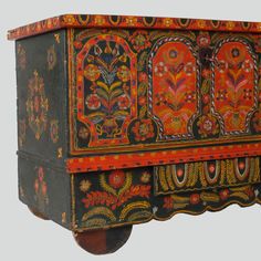 an old wooden chest with painted designs on it