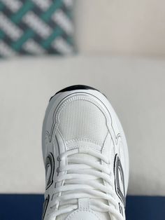 Embrace a sleek and sporty aesthetic with these Dior B30-inspired sneakers in a pristine white colorway. Crafted with breathable mesh and technical fabric, these shoes are perfect for those who value style and performance. The lightweight construction and sculpted rubber sole ensure all-day comfort and support, while the signature "CD30" logo adds a touch of Dior's iconic style. Whether you're hitting the gym or the streets, these sneakers will elevate your look with a touch of understated luxur White Breathable Chunky Lace-up Sneakers, White Breathable Lace-up Chunky Sneakers, White High-top Chunky Sneakers For Sports, White Breathable Chunky Sneakers For Jogging, White Mesh Chunky Sneakers With Cushioned Footbed, White Chunky Sneakers With Laces For Light Sports, White Chunky Sneakers With Boost Midsole For Athleisure, White Chunky Sneakers For Light Sports, White Athleisure Chunky Sneakers With Boost Midsole