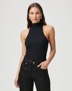 Crafted from a nylon blend with an elevated feel, this chic black tank top is designed with a pleated effect and a halter mock neck silhouette. The Momo Tank is the perfect layering piece to add to your year-round wardrobe. | Momo Tank Top - Black | Size Large Black Turtleneck Tank Top For Spring, Chic Black High Neck Halter Top, Black High Neck Tank Top For Night Out, Chic Black Turtleneck Tank Top, Chic High Neck Tank Top For Night Out, Black High Neck Halter Top For Night Out, Chic High Neck Tank Top For Layering, Sleek Black Halter Top For Night Out, Sleek Black Sleeveless Halter Top