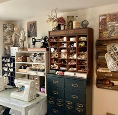 a sewing machine sitting on top of a table next to a shelf filled with items