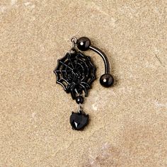 Black Gem Black Spiderweb Halloween Reversible Dangle Belly Ring If you're ready to get into the spirit of Halloween then you will love this 14 gauge navel jewelry with scary style! Made with a 3/8" black plated over 316L surgical grade stainless steel curved barbell, this reversible navel ring features a spiderweb dangle charm with a black gem spider as well as a black gem heart dangle charm that is perfect for trick or treating or a gothic ball.Specifications14 Gauge (1.6mm), 3/8" (10mm), Blac Gothic Piercings For Halloween Gift, Black Piercings For Halloween Gift, Edgy Black Body Jewelry For Gifts, Edgy Black Body Jewelry For Gift, Emo Pierced Jewelry For Halloween, Black Internally Threaded Belly Ring, Black Dangle Emo Jewelry, Spooky Adjustable Black Jewelry, Black Metal Dangle Body Jewelry