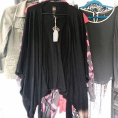 Black Kimono/Poncho Batwing Oversized Shrug/Cardigan By Lucky Brand, New With Tags!! Ties In Front. Can Be Worn Two Ways (See Photo Of Tag). 48% Cotton, 40% Modal, 12% Wool. Hand Wash Cold; Lay Flat To Dry - Or Dry Clean. Due To The Unique Design, Sweater Is Difficult To Measure In Any Practical Way. However, It Measures: 48” Across The Top, 45” Across Bottom, 24” At Sides, And 26” Down The Center. Feel Free To Ask Any Questions. I Am In The Process Of Listing Many Items, So I Took Some Quick Pi Black Bohemian Poncho With Batwing Sleeves, Black Winter Outerwear With Kimono Sleeves, Black Outerwear With Kimono Sleeves For Winter, Black Batwing Sleeve Poncho For Spring, Bohemian Black Poncho For Fall, Casual Black Tops With Kimono Sleeves, Black Shawl Outerwear For Festival, Black Oversized Tops For Festivals, Oversized Black Tops For Festival