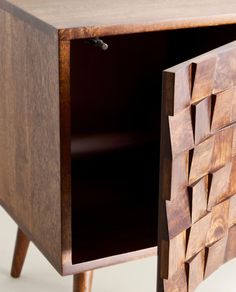 a wooden sideboard with an open drawer