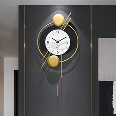 a clock on the wall in a room with black and white walls, gold accents