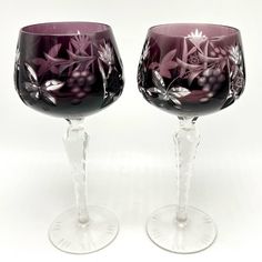 Pair of 2 Czech Bohemian Amethyst Purple Cut to Clear Wine Glasses or Goblets  Stemmed glass barware, beautiful decorative display pieces Hold 7-8 ounces Measure 8 inches tall Preowned, lightly used. Please see photos Vintage set classic traditional vineyard grapes leaves flowers ornate eclectic special occasion kitschy beautiful glassware decorative drinkware Grapes Leaves, Glass Goblets, Purple Wine, Photos Vintage, Amethyst Purple, Leaf Flowers, Grape Leaves, Stemware, Cut Glass