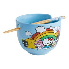 a blue bowl with chopsticks in it and hello kitty on the side,