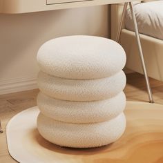 a stack of white towels sitting on top of a wooden floor