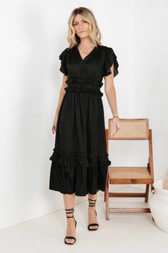 RUFFLE DRESS IN BLACK Black Midi Dress With Sleeves, Black V-neck Dress With Ruffles, Black Flowy Maxi Dress With Flutter Sleeves, Chic Black Ruffle Dress With Ruffle Hem, Flowy Black Maxi Dress With Flutter Sleeves, Black V-neck Maxi Dress With Ruffles, Black V-neck Ruffled Maxi Dress, Black Ruched Tiered Dress, Black Tiered Ruched Dress