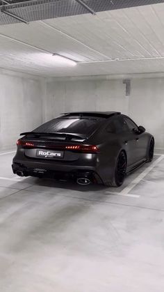 a black sports car parked in a parking garage