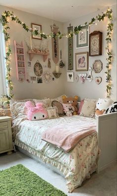 a dog laying on top of a bed in a bedroom next to two stuffed animals