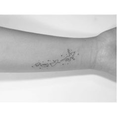 a woman's arm with a small star tattoo on it