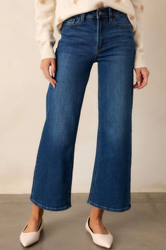 Reach new heights of style with our Into The Clouds Dark Wash Cropped Wide Leg Jeans. These trendy jeans are perfect for any fashion-forward individual looking to make a statement. Breathable fabric and a flattering fit make these jeans a must-have for any wardrobe. Don't be afraid to stand out with these unique and playful jeans! These dark wash jeans feature a high waisted design, classic button & zipper closure, belt loops, functional front & back pockets, and a cropped length. 96% Cotton, 3% Elasterell, 1% Spandex Unlined Manufactured in Vietnam Designed in USA Model is wearing a size 0 Corporate Chic, Preppy Girls, Going Out Looks, Rush Dresses, Cropped Wide Leg Jeans, Trendy Jeans, Long Crop Top, Cardigan Crop, Concert Looks