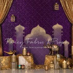 a purple and gold stage set up for a fancy event with lights, candles and decorations