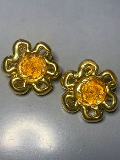 "SUPERB JACKY DE G FRANCE GOLD DIPPED METAL FLOWER YELLOW/ORANGE RESIN STATEMENT FRENCH DESIGNER RARE 1980s RUNWAY COUTURE SIGNED CLIP ON EARRINGS !! A FABULOUS pair of vintage 1980's floral clip on earrings by the french designer \"Jacky de G\". Featuring beautiful ornate gold dippen resin flowers with small yellow/orange resin roses in the centre. The detailed design is so beautiful. Full for french runway glamour ! Very eyecatching. SIGNED DG PARIS on the back of both earrings  MEASUREMENTS: Retro Gold Flower Jewelry, Gold Flower Earrings For Spring Party, Vintage Jewelry For Spring Party, Spring Party Gold Clip-on Earrings, Gold Clip-on Earrings For Spring Party, Gold Flower Clip-on Earrings For Spring, Retro Yellow Earrings For Party, Retro Yellow Party Earrings, Retro Gold Clip-on Earrings For Party