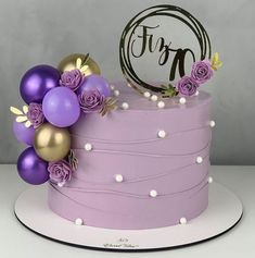 a cake with purple and gold decorations on top