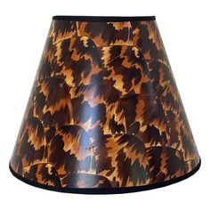 a lamp shade with an orange and black pattern on it