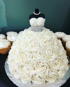 a wedding dress made out of cupcakes on top of a cake platter