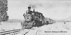 an old black and white photo of a train traveling down the tracks in the country