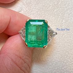 Absolutely stunning Colombian emerald mounted with 18k yellow gold  and platinum shank ! The 7.25CT emerald is from Colombia, beautiful rich green color and good clarity for its size. There are two sparkly trillion cut white diamonds adorning the center stone totaling 1.8 carat! I never understand the term "emerald garden" until I see this ring! The emerald has beautiful natural imperfections! This ring comes with one certification: Gemological Institute of America (GIA) Ring Size: 7 Total Weigh Never Understand, Colombian Emeralds, Rich Green, Yellow Gold Ring, White Diamonds, Ring Size 7, Solid Yellow, Yellow Gold Rings, Rings Statement