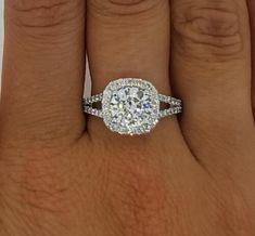 a woman's hand with a diamond ring on her finger and an engagement band