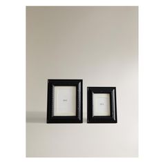 two black frames sitting next to each other