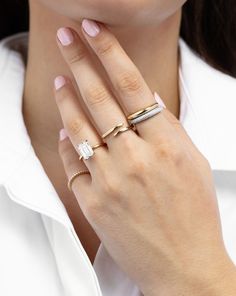 a woman wearing two rings on her finger