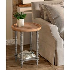 a small wooden table with a plant on it