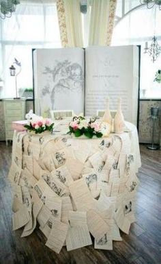 a table covered with lots of books and flowers