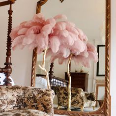 a large mirror sitting on top of a table next to a couch