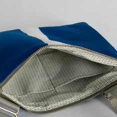 Our crossbody pouch now comes in a stunning blue and white pattern! With a slim profile that expands to hold your keys, phone, card holder and more, this pouch is classic and functional. Upcycled like all of our bags, this crossbody pouch was handcrafted by a woman in recovery and was uniquely designed from a pair of pants worn by the West Point Concert/Marching Band and the Hellcats field music group. Purchase this upcycled, crossbody pouch and create possibilities for women on our team to sust Blue Phone Bag With Cell Phone Pocket For On-the-go, Blue Crossbody Phone Bag For Everyday, Blue Travel Pouch For Mobile Phone, Blue Mobile Phone Pouch For Travel, Blue Mobile Phone Travel Pouch, Blue Shoulder Bag With Zipper Closure As Gift, Blue Shoulder Bag With Zipper Closure, Ideal As Gift, Blue Phone Bag With Zipper Closure, Blue Rectangular Phone Bag For Everyday Use