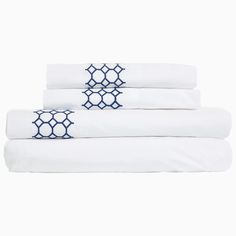 three white sheets with blue geometric designs on them