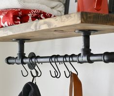 a coat rack with hooks and coats hanging on it