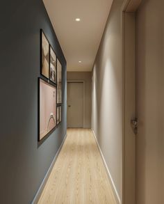 an empty hallway with framed pictures on the wall