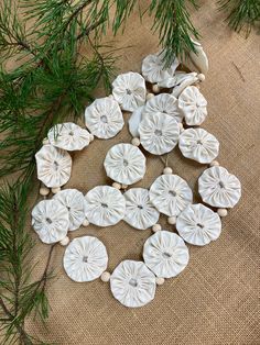 white ceramic ornaments are arranged on a burlock