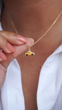 Introducing the delightful enamel 14k gold car charm, perfect for adding a touch of sweetness to your jewelry collection! Handcrafted with love and attention to detail, this charming piece features a beautiful yellow enamel finish, nestled on a gleaming 14k gold. The luscious enamel color pops against the shiny gold, creating a stunning contrast that will catch the eye of anyone who sees it. This lovely gold taxi charm is not only beautiful but also durable, thanks to its high-quality materials Car Necklace, Memory Necklace, Gold Car, Yellow Car, Memorial Necklace, Enamel Charms, Car Charms, Charm Gift, Dainty Necklace