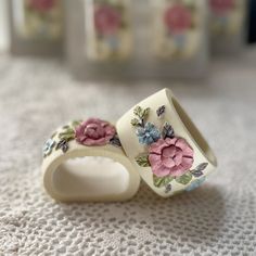 two wedding bands with flowers on them sitting on the floor next to eachother