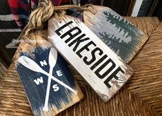 two wooden signs are hanging on a wicker chair