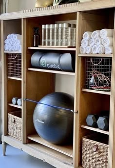 an exercise ball sits on top of a wooden shelf