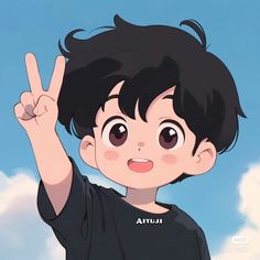 a young boy is making the peace sign with his hand while standing in front of some clouds