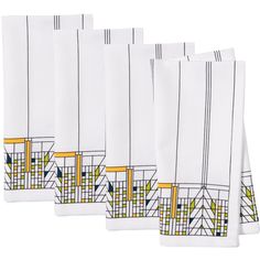 four white napkins with yellow and blue designs on the edges are lined up against each other