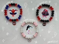 three bracelets with different designs on them sitting on top of a white table next to each other